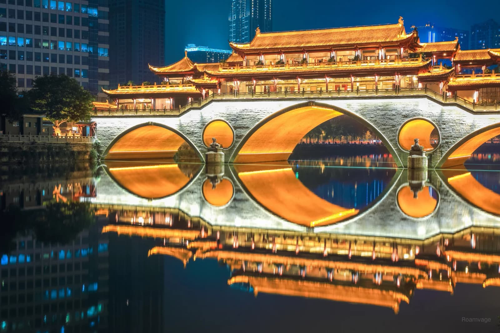 The illuminated Anshun Bridge over the river in Chengdu