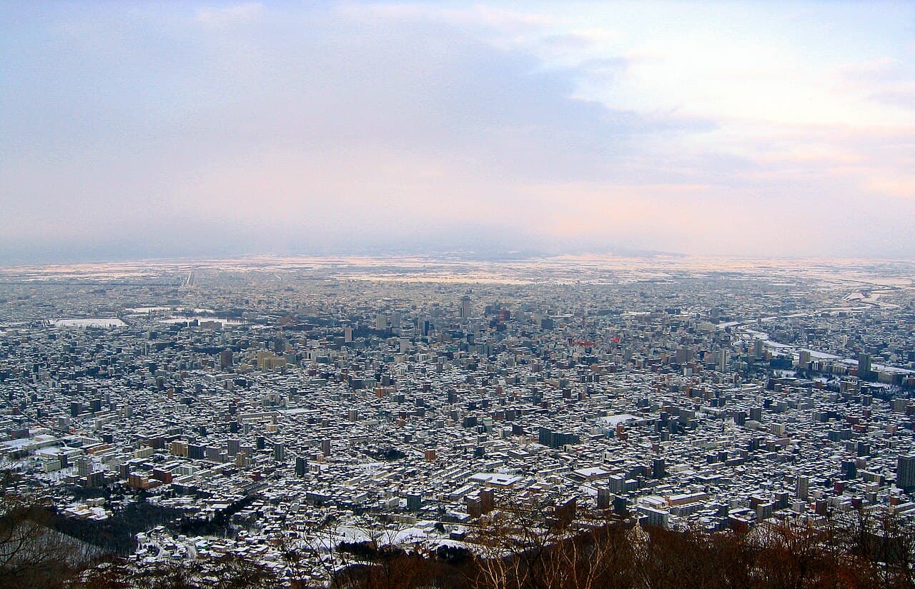Sapporo city and mountains covered in winter snow